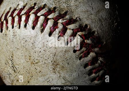 Extreme close up photo an old baseball showing lots of wear and tear from a lot of use Stock Photo