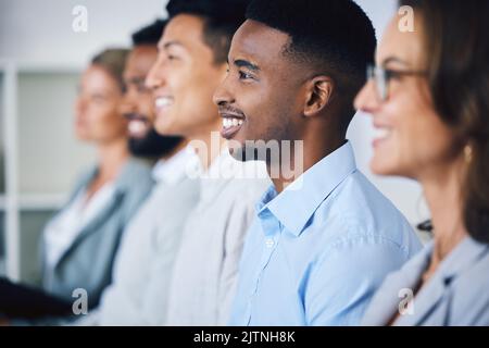 Business, presentation and happy employees in diversity sitting and listening in seminar or workshop at the office. Group of professional workers Stock Photo