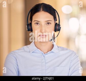 Telemarketing, contact us and customer service support agent ready to provide a good online service. Portrait of a serious sales consultant working at Stock Photo