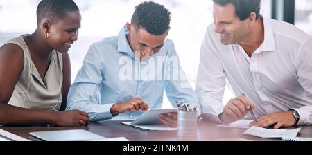 Business people planning on tablet in meeting at work, ppartnership for advertising project and collaboration for success in marketing. Employees and Stock Photo