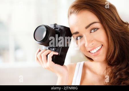 Portrait of happy woman photographer working in model studio doing photoshoot with camera. Career, creative and photography student doing media Stock Photo