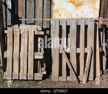 Old used wooden pallets near a rustic  barn Stock Photo