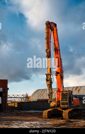 Special excavator destroyer with scissors at demolition site Stock Photo