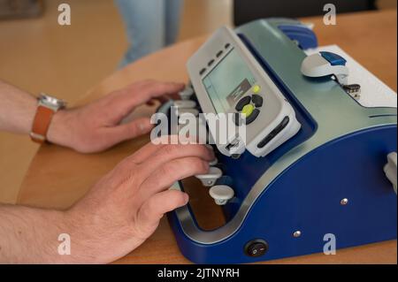 Blind man using braille typewriter.  Stock Photo