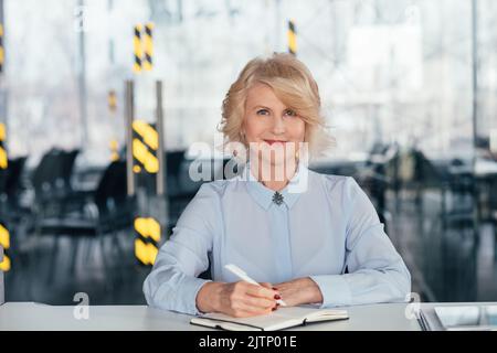 pleased senior business lady diary planning day Stock Photo