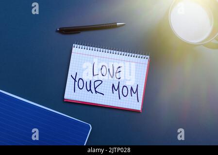Handwriting text Love Your Mom, Word Written on Have good feelings about your mother Loving emotions Man Typing On Lap Top And Woman Pointing With One Stock Photo