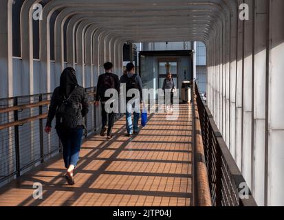 Jakarta, Indonesia-May 27, 2022: Asian people walking on the pedestrian bridge Stock Photo