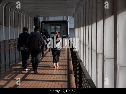 Jakarta, Indonesia-May 27, 2022: Asian people walking on the pedestrian bridge Stock Photo