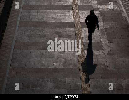 Jakarta, Indonesia-May 27, 2022: top view silhouette of people walking on the sidewalk Stock Photo