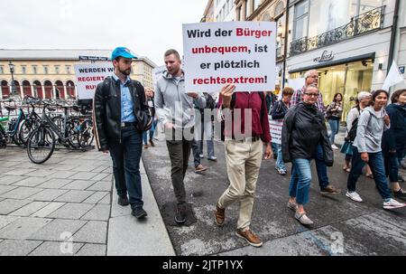 Munich, Bavaria, Germany. 31st Aug, 2022. MARKUS WALLBRUNN of the AfD |(left). Under massively increased police presence after an attack on a Bayerischer Rundfunk reporter, under six hundred Corona rebels, anti-vaxxers, Reichsbuerger (sovereign citizens), and some who may be part of a regrouping Identitaere Bewegung marched through the streets of Munich with speeches increasingly taking on more Reichsbuerger character, such as an untrue identification via vaccination QR codes seemingly being described as part of the strawman theory, for example. (Credit Image: © Sachelle Babbar/ZUMA Press Wi Stock Photo