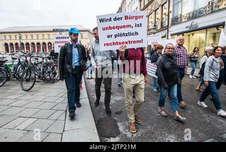 Munich, Bavaria, Germany. 31st Aug, 2022. MARKUS WALLBRUNN of the AfD |(left). Under massively increased police presence after an attack on a Bayerischer Rundfunk reporter, under six hundred Corona rebels, anti-vaxxers, Reichsbuerger (sovereign citizens), and some who may be part of a regrouping Identitaere Bewegung marched through the streets of Munich with speeches increasingly taking on more Reichsbuerger character, such as an untrue identification via vaccination QR codes seemingly being described as part of the strawman theory, for example. (Credit Image: © Sachelle Babbar/ZUMA Press Wi Stock Photo