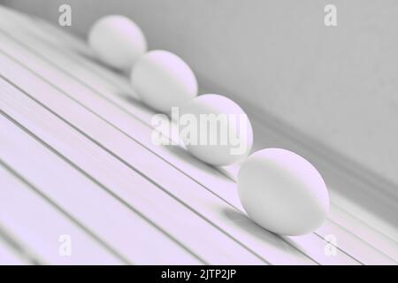 Four eggs on a white striped surface.Black white photo Stock Photo