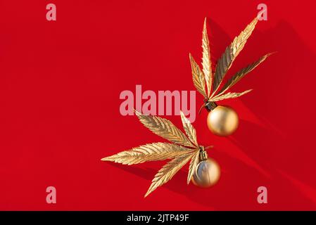 Golden Christmas balls with golden leaves of marijuana on red ...