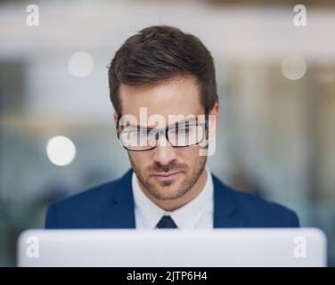 Fully focused. a young businessman working in his office. Stock Photo