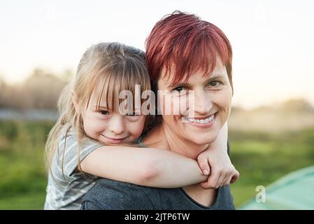 Mommy is my best friend. Cropped portrait of a little girl and her mother standing outside. Stock Photo