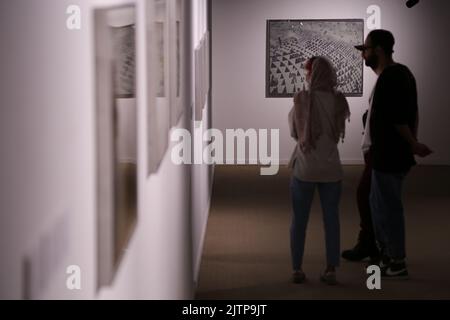 Tehran, Tehran, Iran. 30th Aug, 2022. Iranian visitors look at conceptual artworks while visiting, the ''Minimalism and Conceptual Art'' exhibition, which showcases works from the 19th and 20th centuries by American and European artists, at the Tehran Museum of Contemporary Art in the Iranian capital on August 30, 2022. More than 20,000 people have flocked to an Iranian museum showcasing dozens of renowned Western artists' works, some for the first time -- part of a treasure trove amassed before the Islamic Revolution. The museum's collection is reputed to be the greatest line-up of modern ma Stock Photo