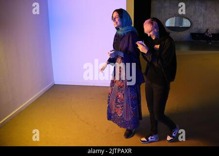 Tehran, Tehran, Iran. 30th Aug, 2022. Iranian visitors look at an installation by American artist Dan Flavin, during the ''Minimalism and Conceptual Art'' exhibition, which showcases works from the 19th and 20th centuries by American and European artists, at the Tehran Museum of Contemporary Art in the Iranian capital on August 30, 2022. More than 20,000 people have flocked to an Iranian museum showcasing dozens of renowned Western artists' works, some for the first time -- part of a treasure trove amassed before the Islamic Revolution. The museum's collection is reputed to be the greatest li Stock Photo