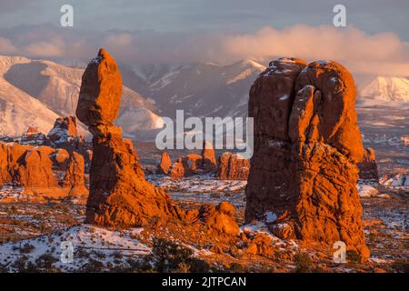 Balanced Rock, Owl Rock and Turret Arch behind after a winter snowfall in Arches National Park, Moab, Utah. Stock Photo