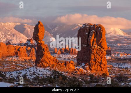 Balanced Rock, Owl Rock and Turret Arch behind after a winter snowfall in Arches National Park, Moab, Utah. Stock Photo