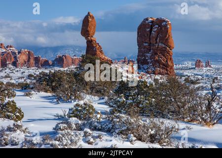 Balanced Rock after a winter snowfall in Arches National Park, Moab, Utah. Stock Photo