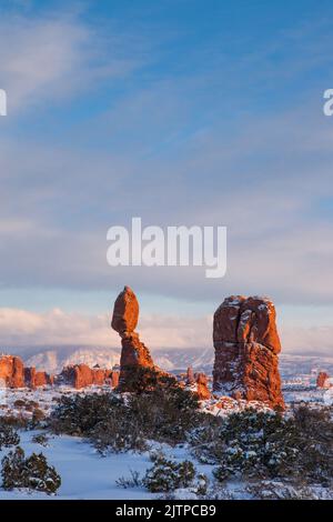 Balanced Rock after a winter snowfall in Arches National Park, Moab, Utah. Stock Photo