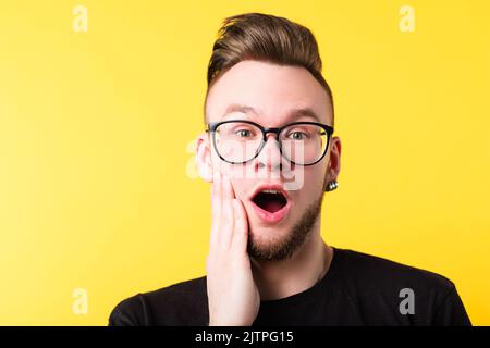 impressed surprised millennial guy portrait Stock Photo