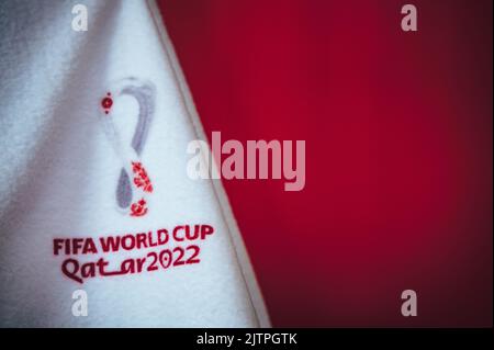 DOHA, QATAR, AUGUST 30, 2022: Red Background For FIFA World Cup in Qatar 2022. Football World Championship official logo on white blanket. Red Edit Sp Stock Photo