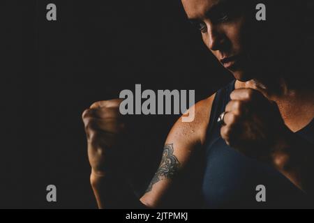 Middle age mature lady looking bad in boxe defence posture pose. Concept of woman athlete training hard. Empowerment and sport activity for female peo Stock Photo