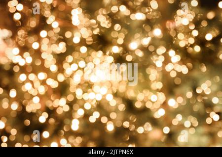 Blurred abstract background with defocused golden garland. Stock Photo