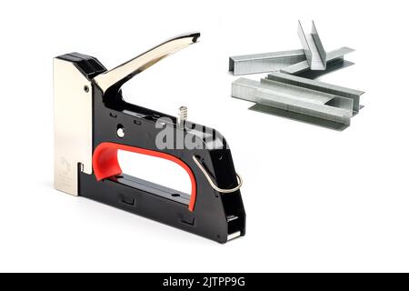 Staple gun with staples isolated on white background. Heavy-duty steel staple gun to repairs around your home. Stock Photo