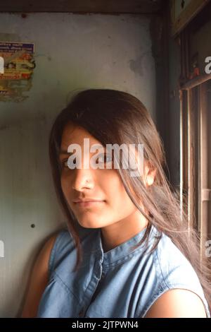 A young Indian women posing for photo in train. Stock Photo