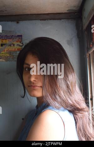 A young Indian women posing for photo in train. Stock Photo