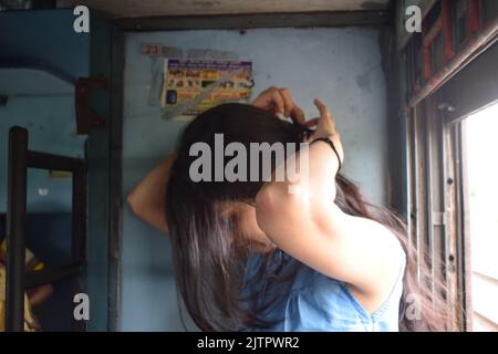 A young Indian women posing for photo in train. Stock Photo