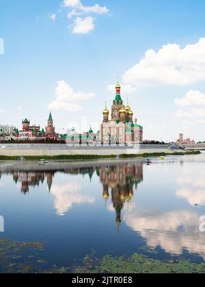 view of Cathedral of the Annunciation of the Blessed Virgin Mary reflects in water surface of Malaya Kokshaga river in Yoshkar-ola city on sunny summe Stock Photo