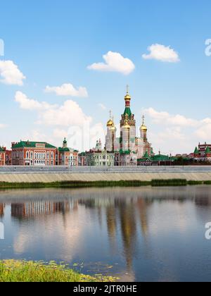 Blagoveshchenskiy Sobor on Voskresenskaya embankment of Malaya Kokshaga river in Yoshkar-ola city on sunny summer day Stock Photo