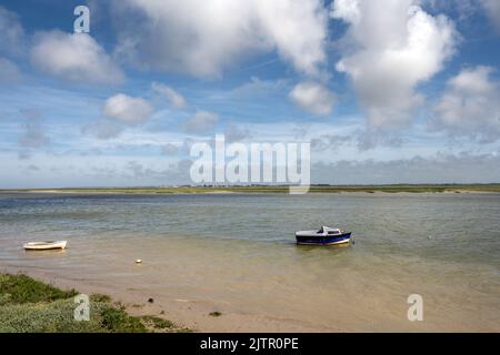 Little blue boat on the Bay of Somme on a cloudy spring afternoon, Hauts-de-France, France Stock Photo