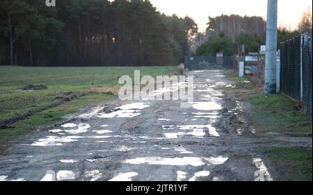 Dirt road after rain. Puddles and mud on the road. Stock Photo