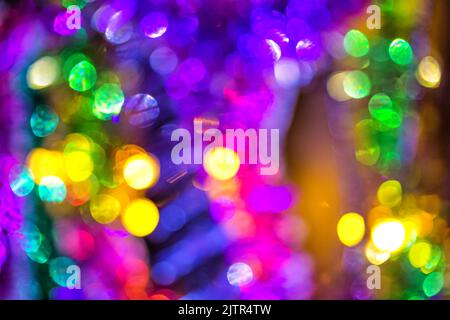 Holiday lighting and decoration concept - christmas garland with bokeh lights on dark blue background, defocused Stock Photo