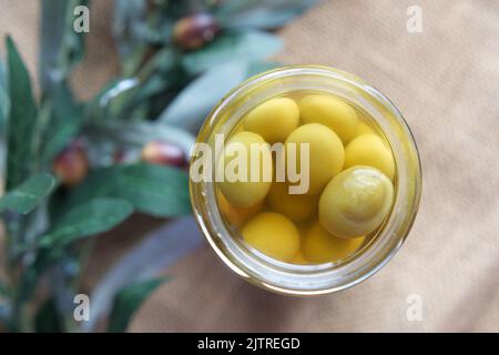 fresh olive in a container on table . Stock Photo