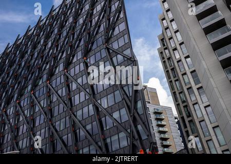 Paddington Basin, London. A regenerated area of Paddington, along the canal, with a walkway, cafes and restaurants along with modern apartments. Stock Photo