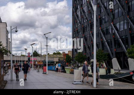 Paddington Basin, London. A regenerated area of Paddington, along the canal, with a walkway, cafes and restaurants along with modern apartments. Stock Photo