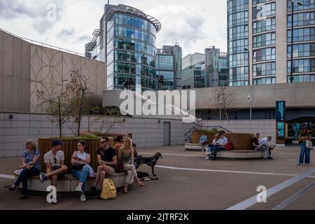 Paddington Basin, London. A regenerated area of Paddington, along the canal, with a walkway, cafes and restaurants along with modern apartments. Stock Photo