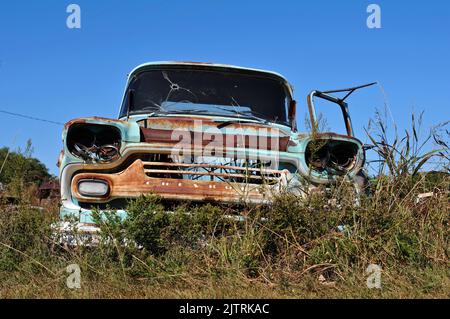 A rusting old Chevrolet truck sits abandoned in a field along Route 66 in Oklahoma. Stock Photo