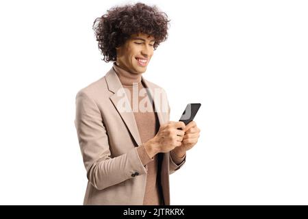 Elegant young man with curly hair typing on a smartphone isolated on white background Stock Photo