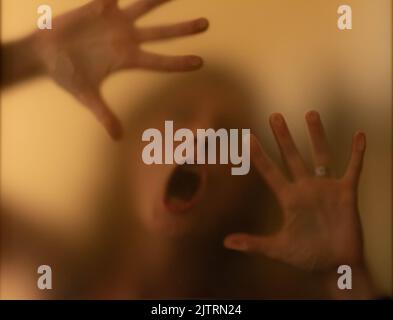 scary picture of hands behind glass Stock Photo