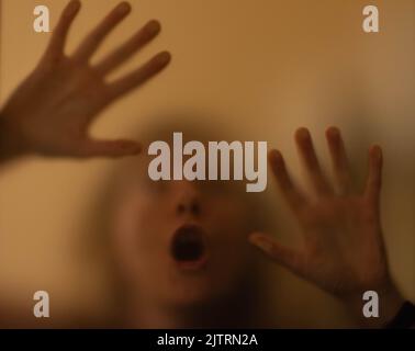 scary picture of hands behind glass Stock Photo