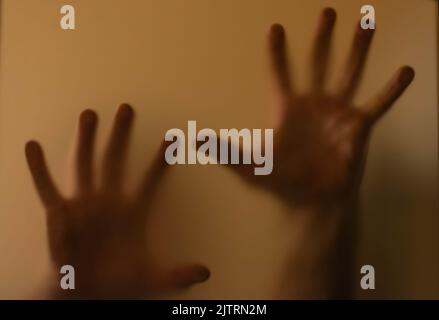 scary picture of hands behind glass Stock Photo