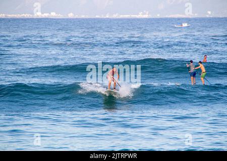 Man practicing stand up paddle at Copacabana beach in Rio de Janeiro, Brazil - March 7, 2020: Man practicing stand up paddle at post six on Copacabana Stock Photo