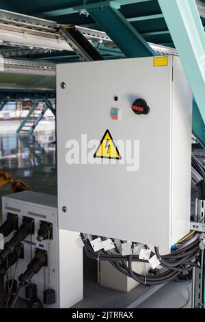 Grey Hinged Power Supply Box in industrial workshop Stock Photo