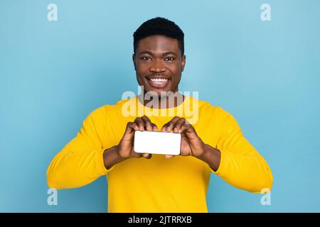photo of sell assistant guy offer mobile device application auto turn swipe wear long sleeve nice shirt isolated blue color background Stock Photo